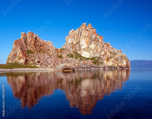 View of a rock on the Lake Baikal in the early sunny summer morning.