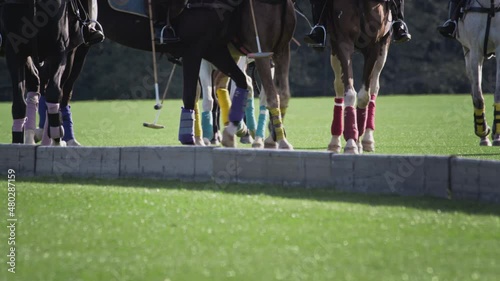 Polo game, two teams on horseback in slow motion. Horseback riding. Polo in the grass arena, equestrian sports in the stadium. Strikes the ball with a wooden mallet. Luxury polo club for celebrities. photo