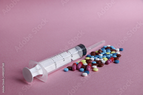 Close up of medical tablets and pills and drugs and syringes