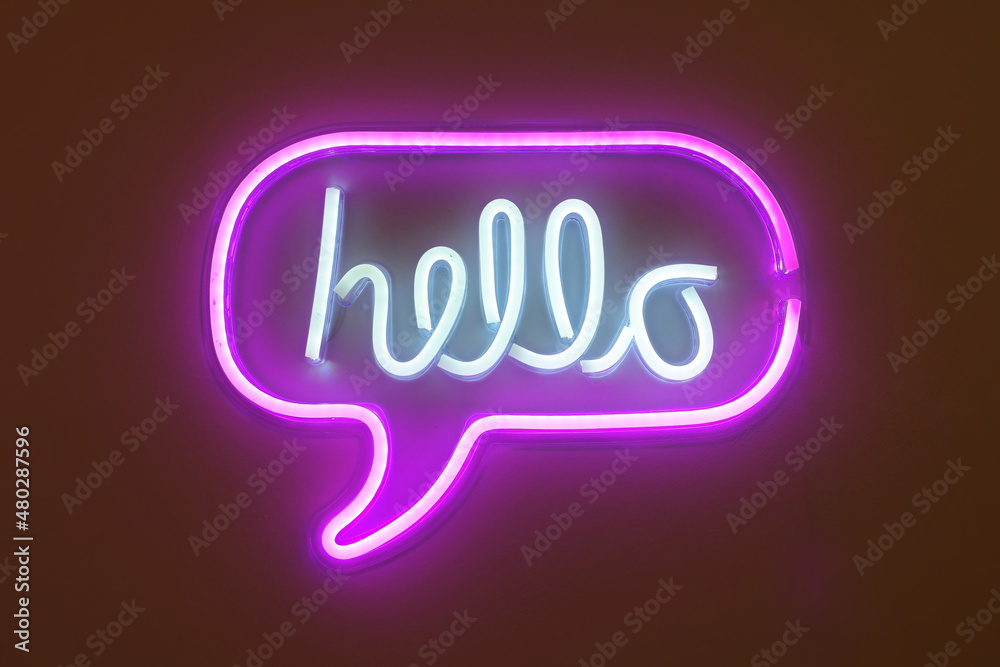 A neon sign in the shape of a speech bubble that says hello.