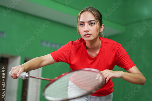 close up of female badminton player holding racket