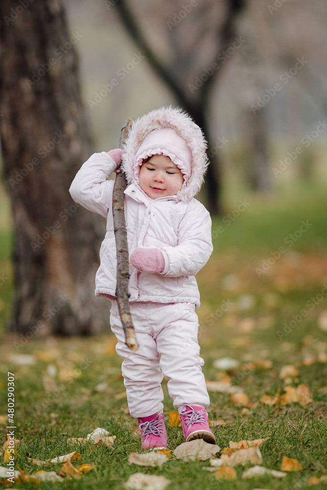 A little girl in winter park without snow, because of global warming A little girl in winter park without snow, because of global warming