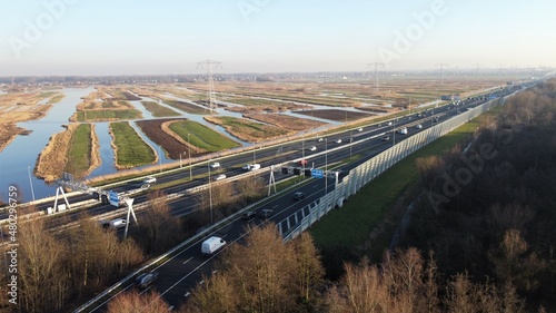 Highway photographed from the air with a drone. Along the Dutch city of Zaandam in the Netherlands with a polder landscape in the background. Choose destination and arrive at your goal.