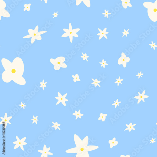 Seamless pattern with flowers. Abstract cute pattern with white flowers on a blue background. Random, chaotic pastel background with daisies.