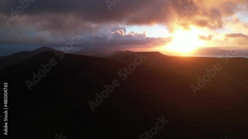 Aerial View of Sunset Above Irish Mountains and Landscape. Conor Pass, County Kerry, Ireland photo