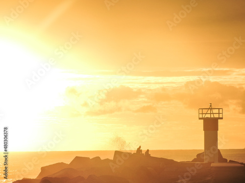 Lighthouse at sunrise with golden glow