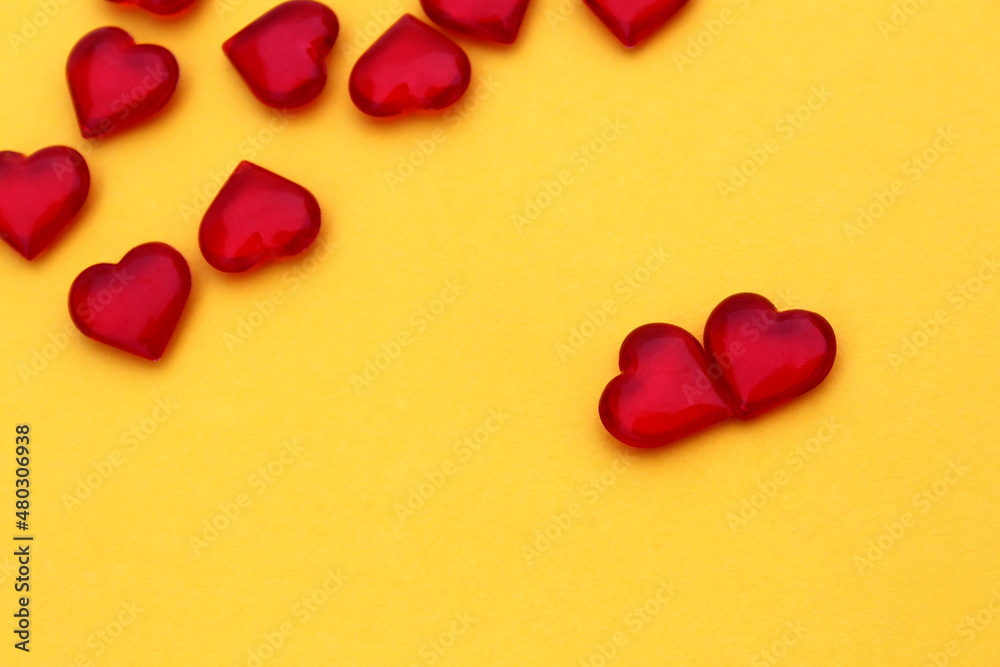 Obraz premium Red hearts lie on a yellow background. Concept for valentine`s day.