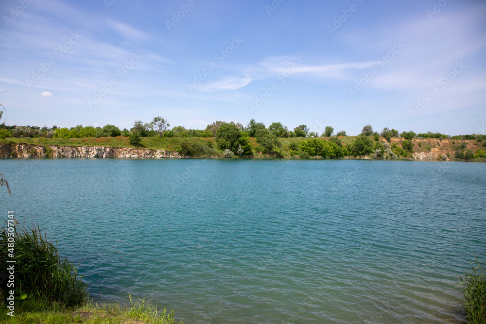 Summer water landscape with rocky river banks