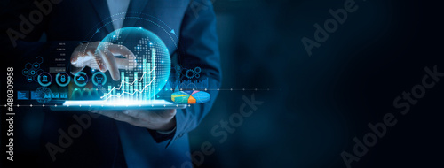 Fotografía Businessman using tablet analyzing sales data and economic graph chart to resume business growth in the economic crisis, Rethink, Reinvent and Recover