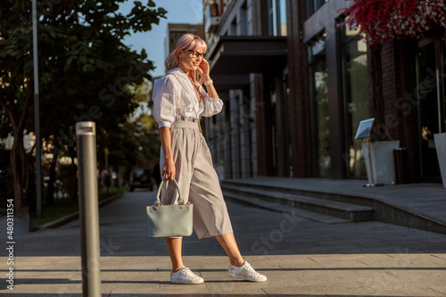 Stylish young woman standing on the street © Kostiantyn