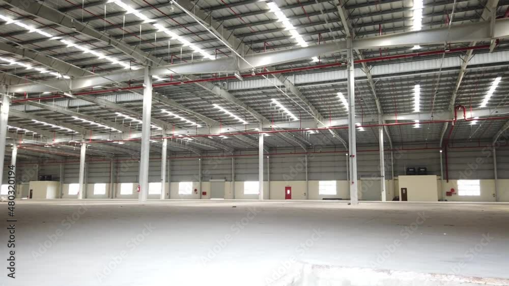 Newly constructed empty warehouse in an industrial area with fire safety systems installed