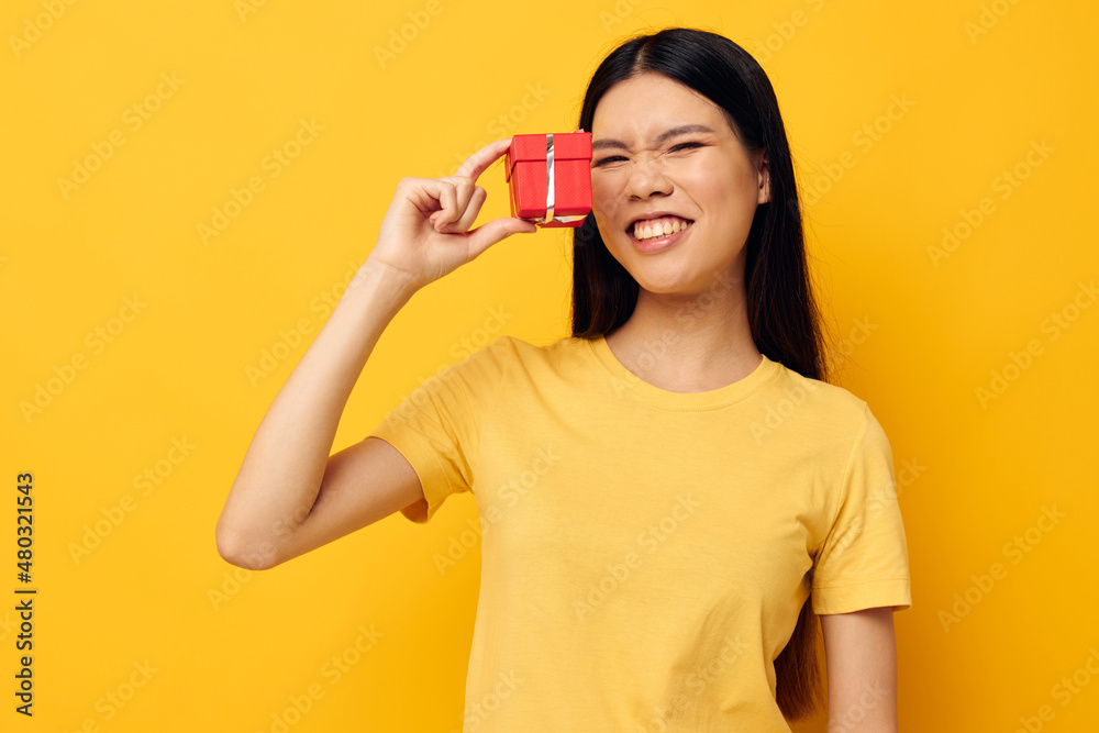 pretty brunette holding a gift box in his hands posing isolated background unaltered