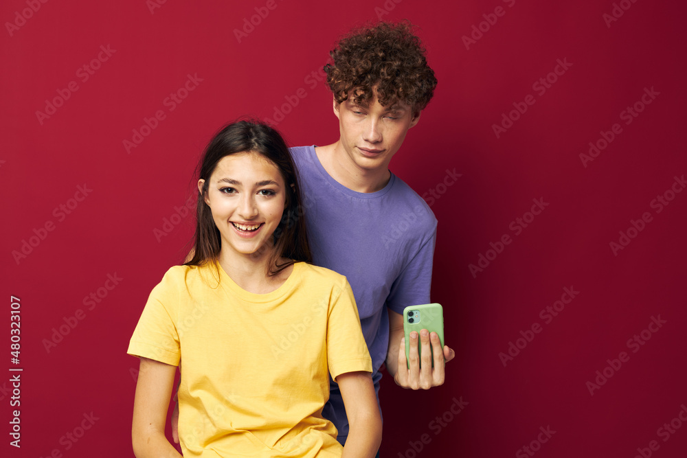 young man and girl modern style emotions fun phone red background young man and girl modern style emotions fun phone red background