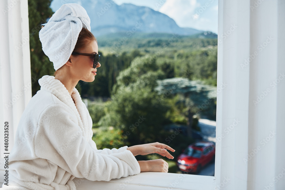 Portrait woman in a bathrobe in the morning on the balcony admiring nature Lifestyle
