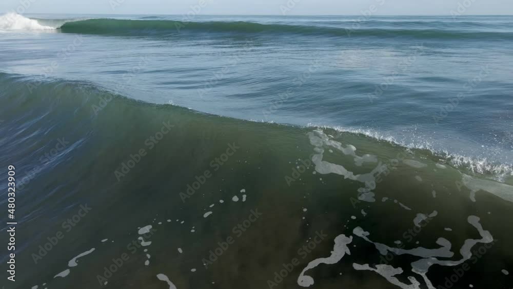 AERIAL - Camera follows deep blue crashing wave AERIAL - Camera follows deep blue crashing wave