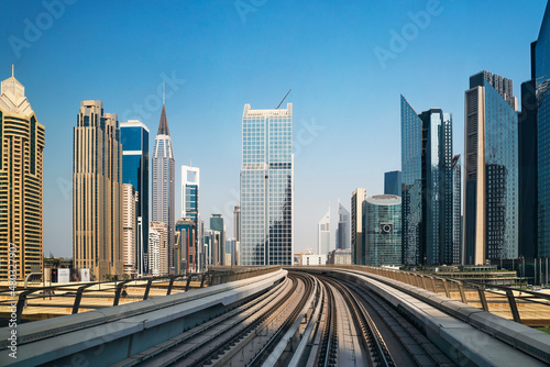 Dubai city center  with skyscrapers and train metro  United Arab Emirates. Financial center with skyscrapers and subway rails.