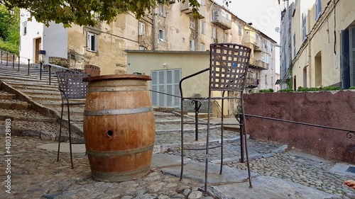 Outdoor seating of hip bar, bar stools around wooden barrel in scenic quarter of Corte, Corsica, France. © Maleo Photography