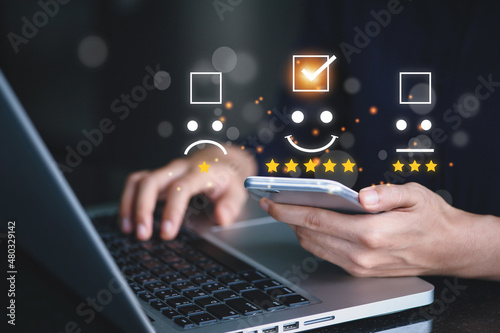 User give rating to service experience on online application for Customer review satisfaction feedback survey concept.