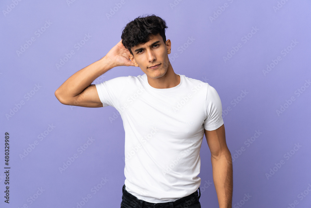 Young Argentinian man isolated on background having doubts Young Argentinian man isolated on background having doubts