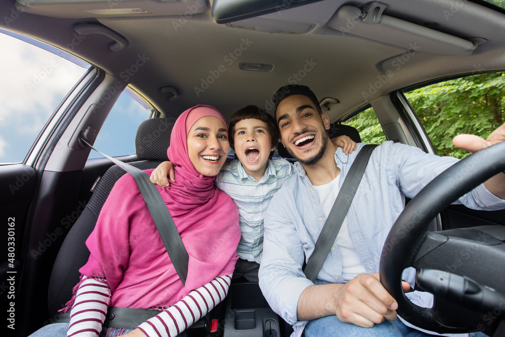 Road Fun. Joyful Muslim Family Of Three Singing In Car Together