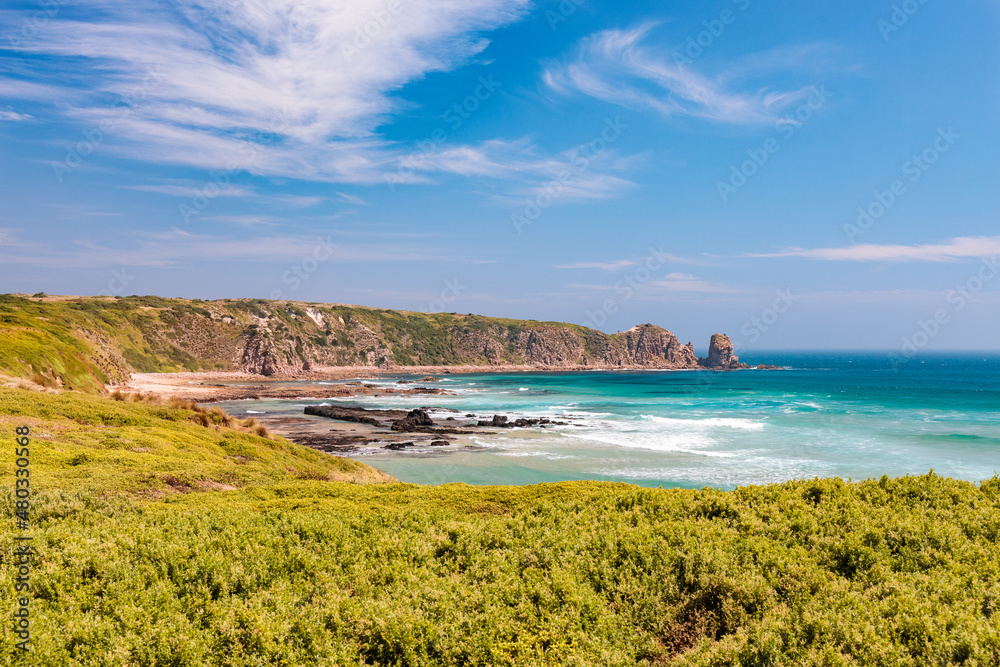 Phillip Island coastline with blue sea, rocks and vegetation. Victoria, Australia. Beautiful Australian beach.