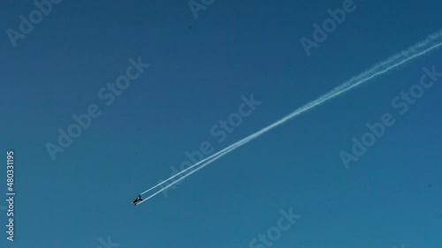 Solo Turk Aircraft Leaving Contrails In Blue Sky During Gdynia Aerobaltic 2021. - tracking shot photo