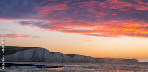 January red dawn sky over the cliffs of the Seven Sisters from Hope Gap at low tide Seaford Head east Sussex coast south east England