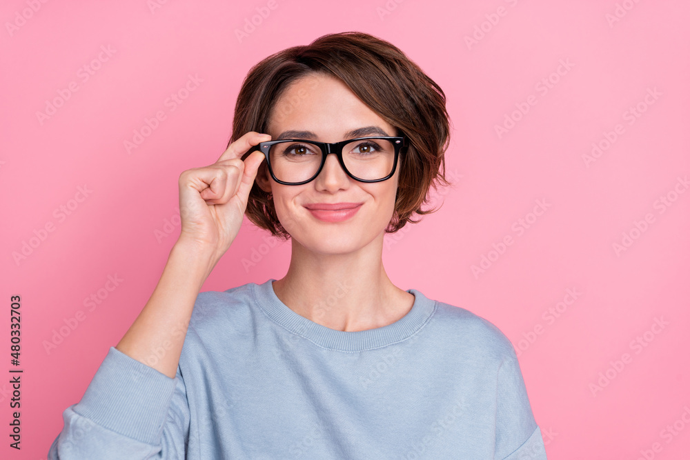 Photo of lovely millennial brunette lady try eyewear wear blue sportscloth isolated on pink color background