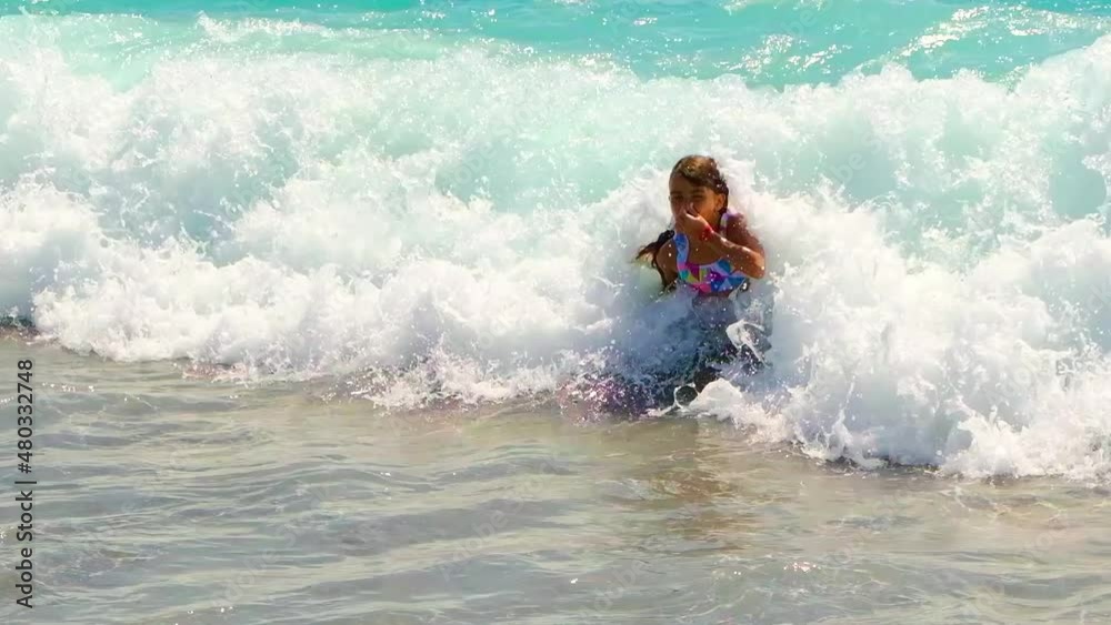 The child is swimming in the sea. Selective focus. The child is swimming in the sea. Selective focus.