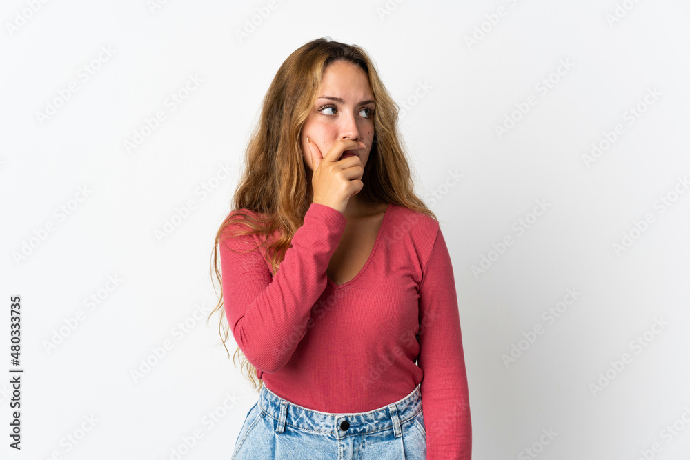 Young blonde woman isolated on blue background having doubts and with confuse face expression Young blonde woman isolated on blue background having doubts and with confuse face expression