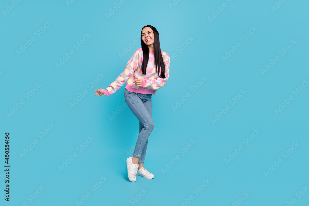 Photo of pretty funky lady dressed print pullover dancing empty space isolated blue color background Photo of pretty funky lady dressed print pullover dancing empty space isolated blue color background