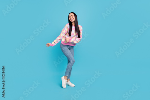 Photo of pretty funky lady dressed print pullover dancing empty space isolated blue color background