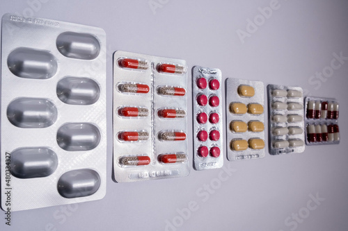 Pharmaceutical medicament, cure in container for health. Pharmacy theme, capsule pills. Various drugs: tablets, blister-packed tablets, pharmaceuticals.