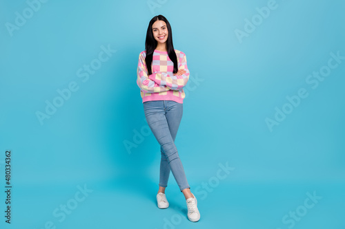 Photo of sweet shiny young woman wear pink sweater arms folded empty space isolated blue color background