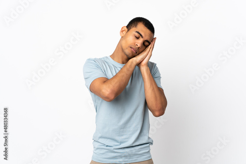 African American man over isolated white background making sleep gesture in dorable expression