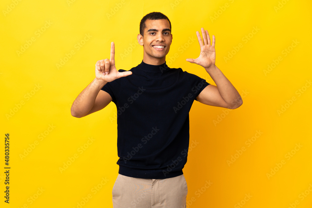 African American man over isolated background counting seven with fingers African American man over isolated background counting seven with fingers