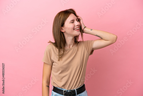 Young English woman isolated on pink background smiling a lot