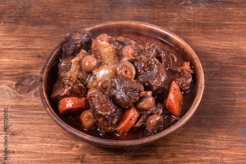 Beef burgundy with champignons in a bowl, close-up