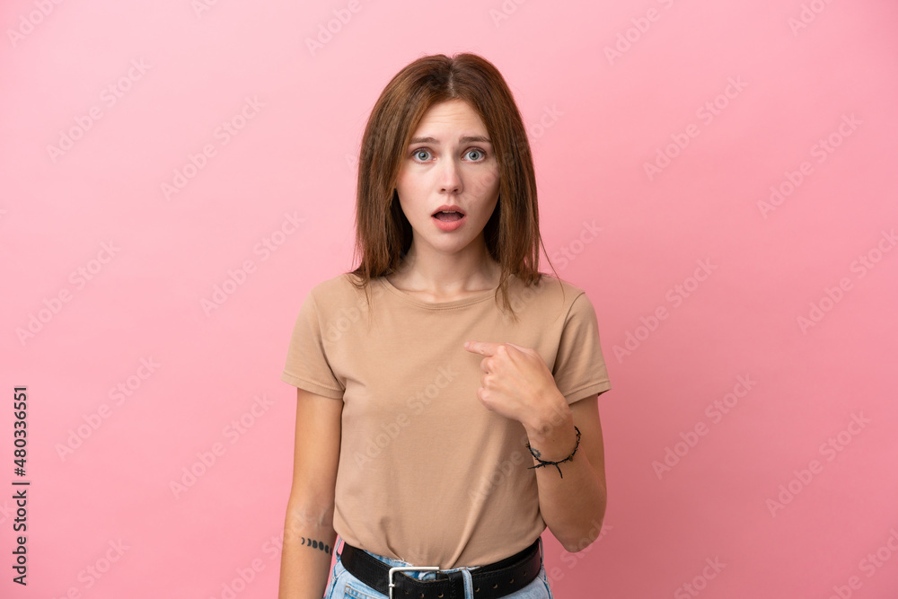Young English woman isolated on pink background pointing to oneself
