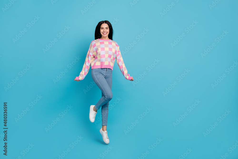 Photo of shiny funny lady dressed print pullover jumping high empty space isolated blue color background