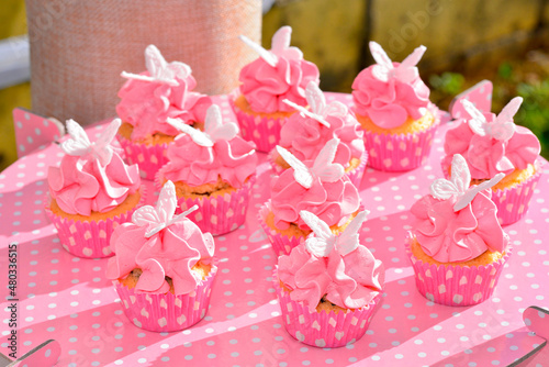 Fototapeta Naklejka Na Ścianę i Meble -  Sweet Candy bar shaped muffins filled with chocolate and strawberry and white fondant butterflies