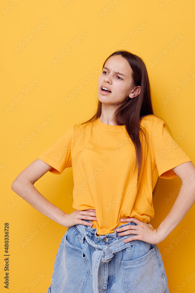 young beautiful woman in a yellow t-shirt emotions summer style isolated background young beautiful woman in a yellow t-shirt emotions summer style isolated background