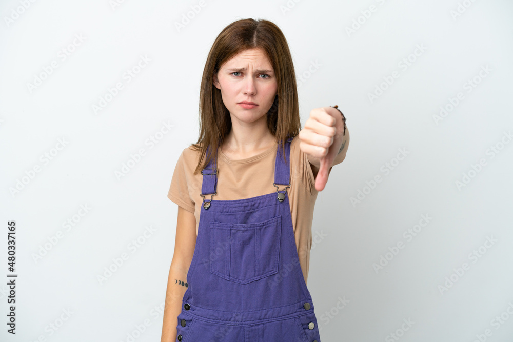 Young English woman isolated on white background showing thumb down with negative expression Young English woman isolated on white background showing thumb down with negative expression