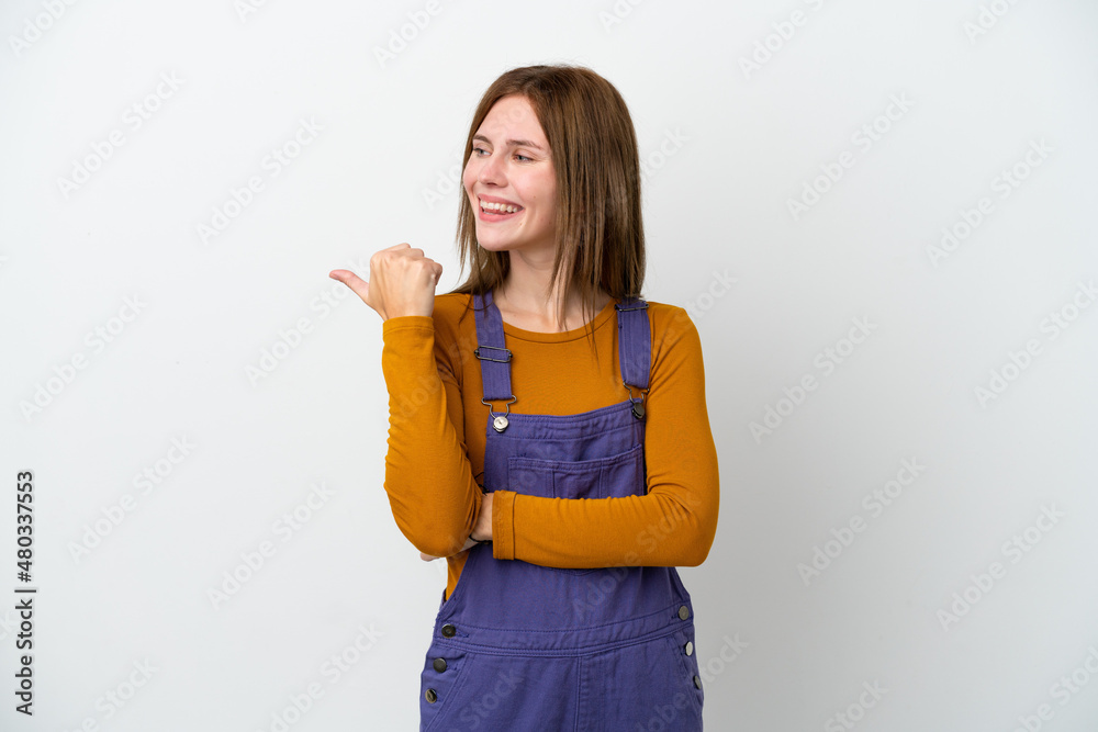 Young English woman isolated on white background pointing to the side to present a product