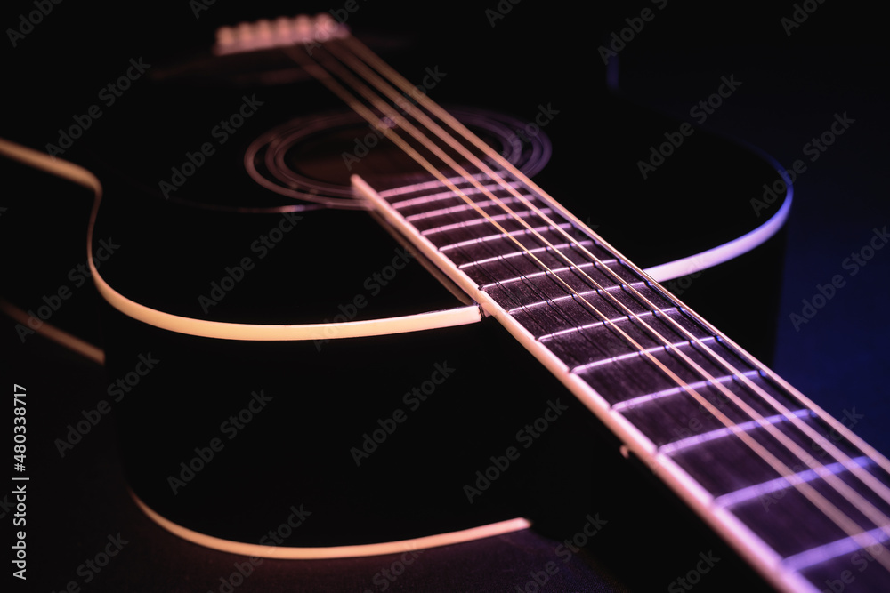 Fototapeta premium black guitar split colored concept. guitar music dark shoot
