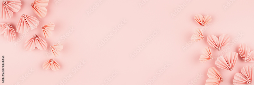 Valentine day banner - flow of flying gentle pink paper ribbed hearts on soft light pink background, top view, copy space, border. Festive love backdrop for website, design, card, poster, text. Valentine day banner - flow of flying gentle pink paper ribbed hearts on soft light pink background, top view, copy space, border. Festive love backdrop for website, design, card, poster, text.