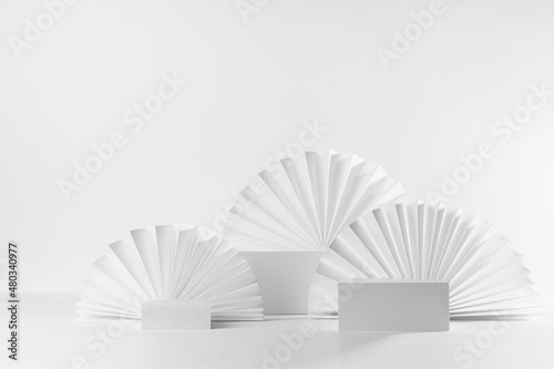 White abstract elegant modern scene with three different size rectangle box podiums mockup for presentation of cosmetic product  advertising  design with oriental folds paper fans in fashion style.