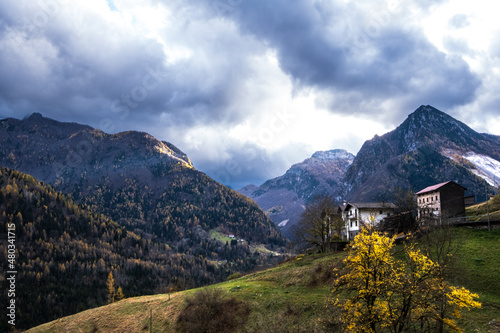 Panoramic view of Alpine town, valley and mountains in autumn