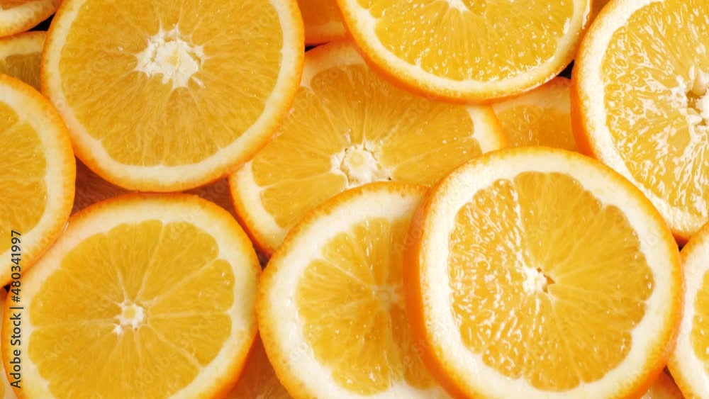Orange fruit. Camera moving up and shows lot of sliced oranges. Close-up Orange fruit. Camera moving up and shows lot of sliced oranges. Close-up