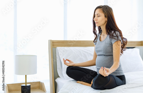 Healthy pregnant Caucasian woman do calm meditation as medical treatment and breath therapy for stress release, anxiety relaxation, mindfulness practice before birth